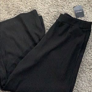 Black knit wide-leg flair pants.